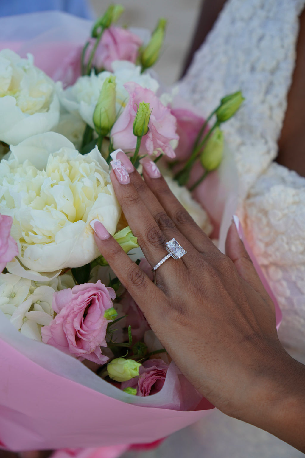 Hand with a ring on a bouquet of flowers