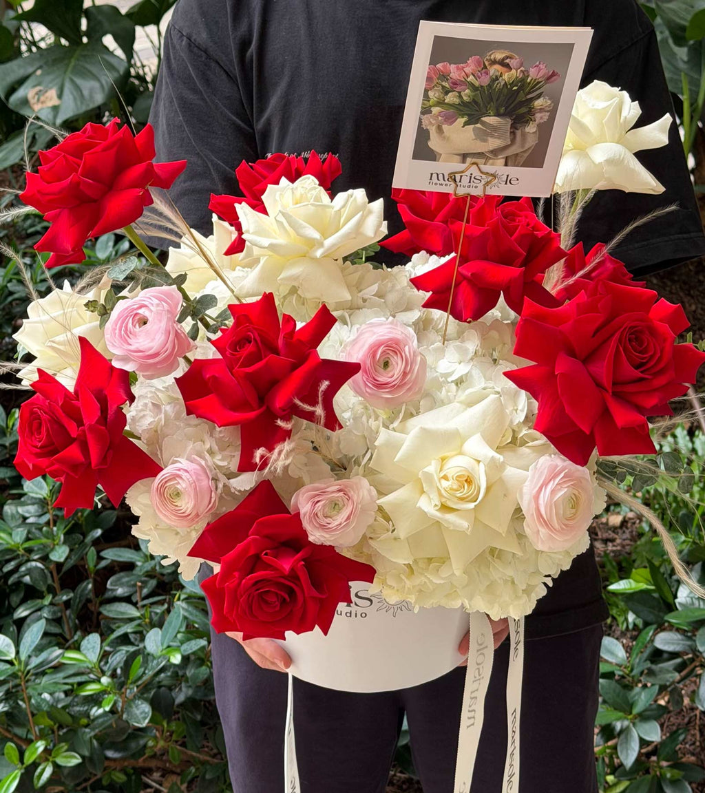 Bordeaux & Blanc Box with red and white roses, hydrangea, ranunculus, dry flowers, and eucalyptus in a Marisole Flower Studio box.
