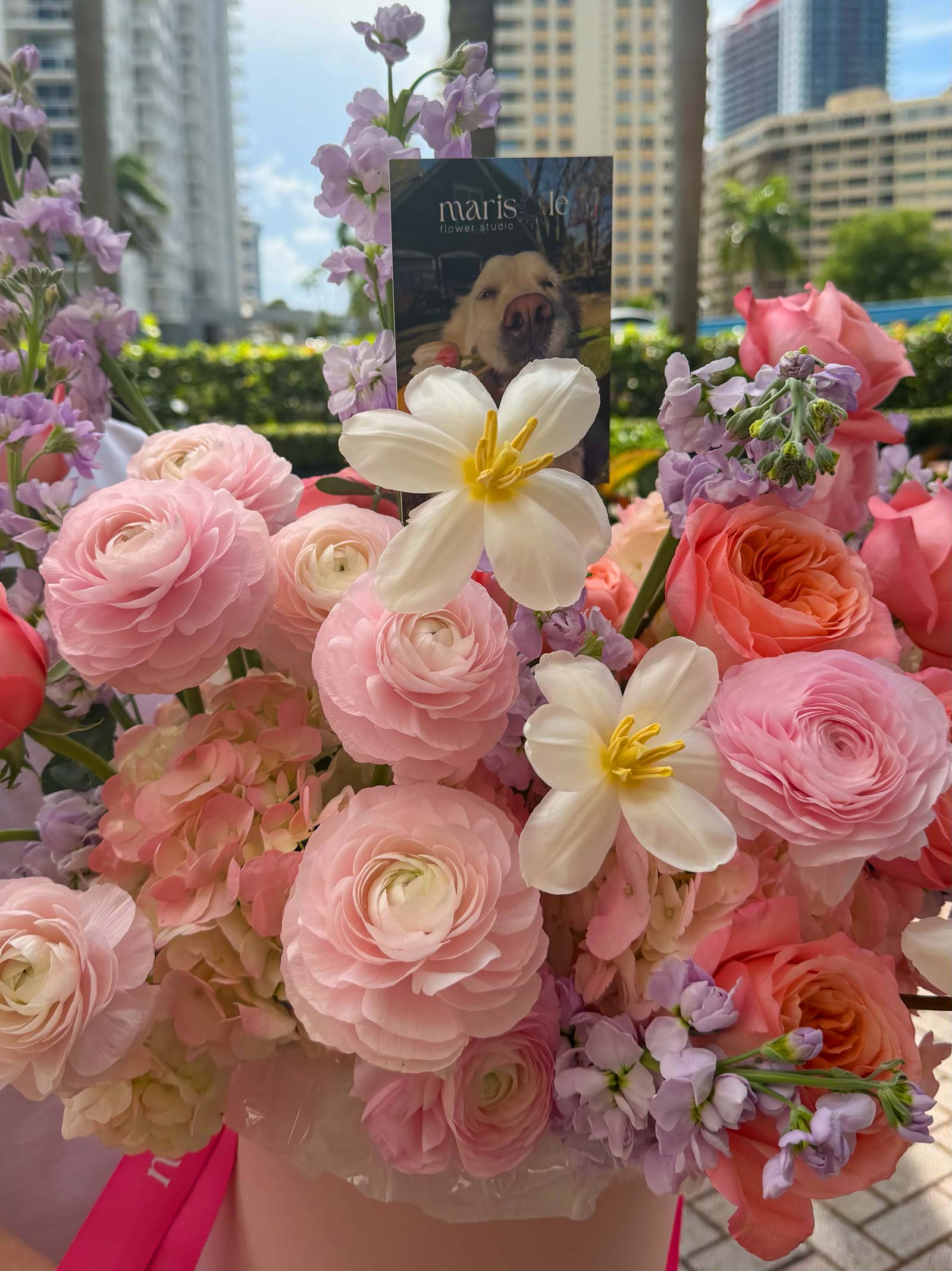 Pink flower box with ranunculus, garden roses, tulips, hydrangea, spray roses, and stock in soft pastel tones, featuring Marisole Flower Studio styling.