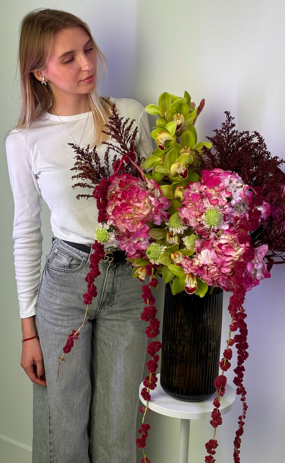 Person holding a large bouquet of flowers with a white background