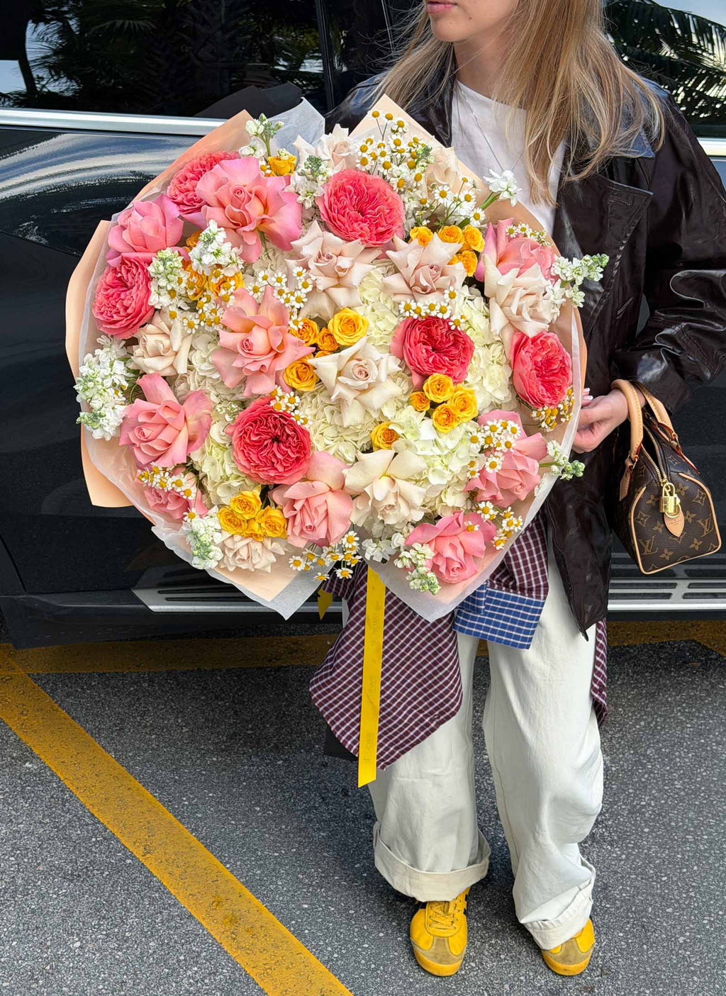 Close-up of the oversized Golden Hour Bouquet with pink garden roses, cream French roses, white hydrangeas, yellow spray roses, and chamomile.