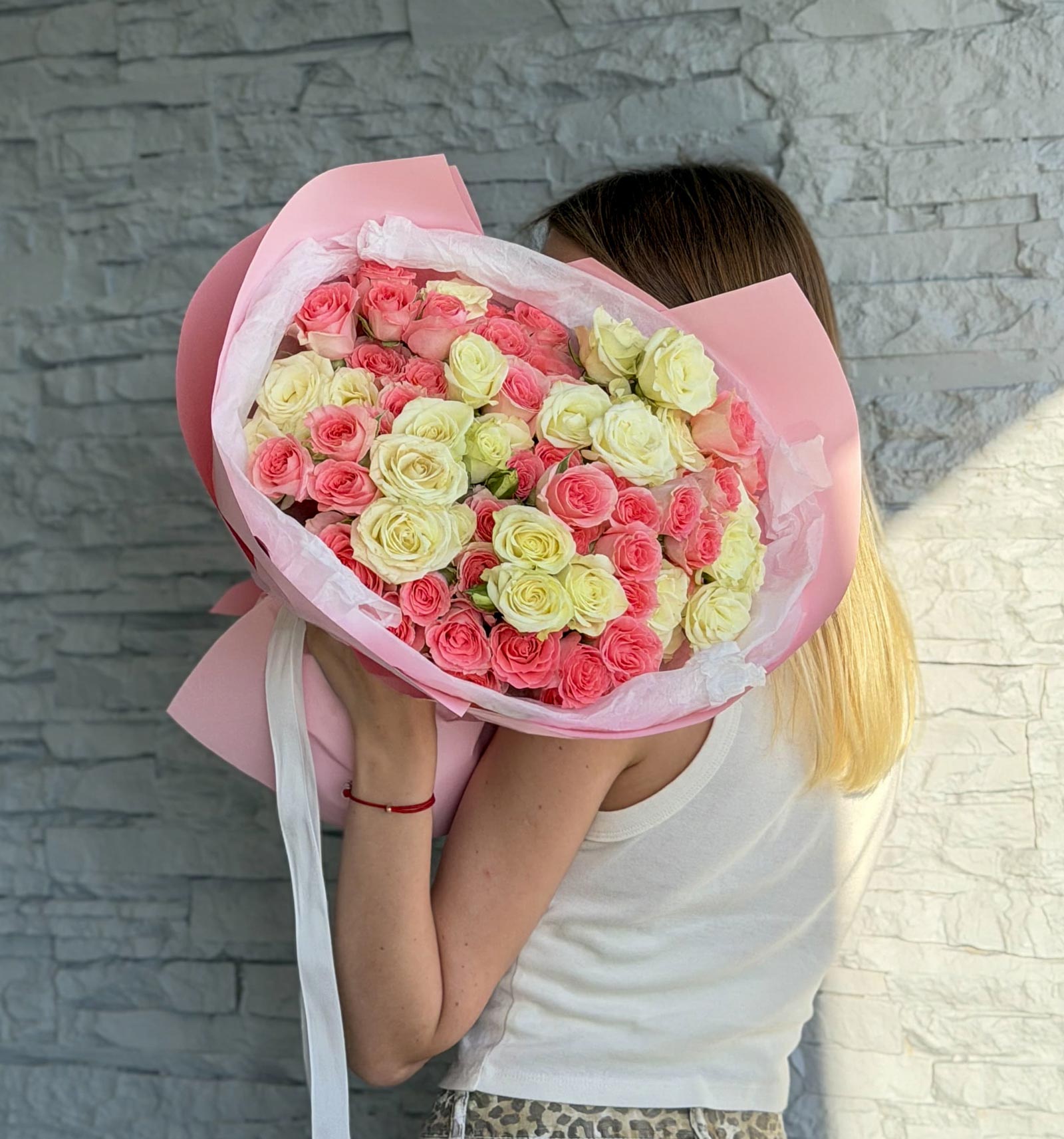 Morning Kiss bouquet of 20 pink and cream spray roses wrapped in pink paper