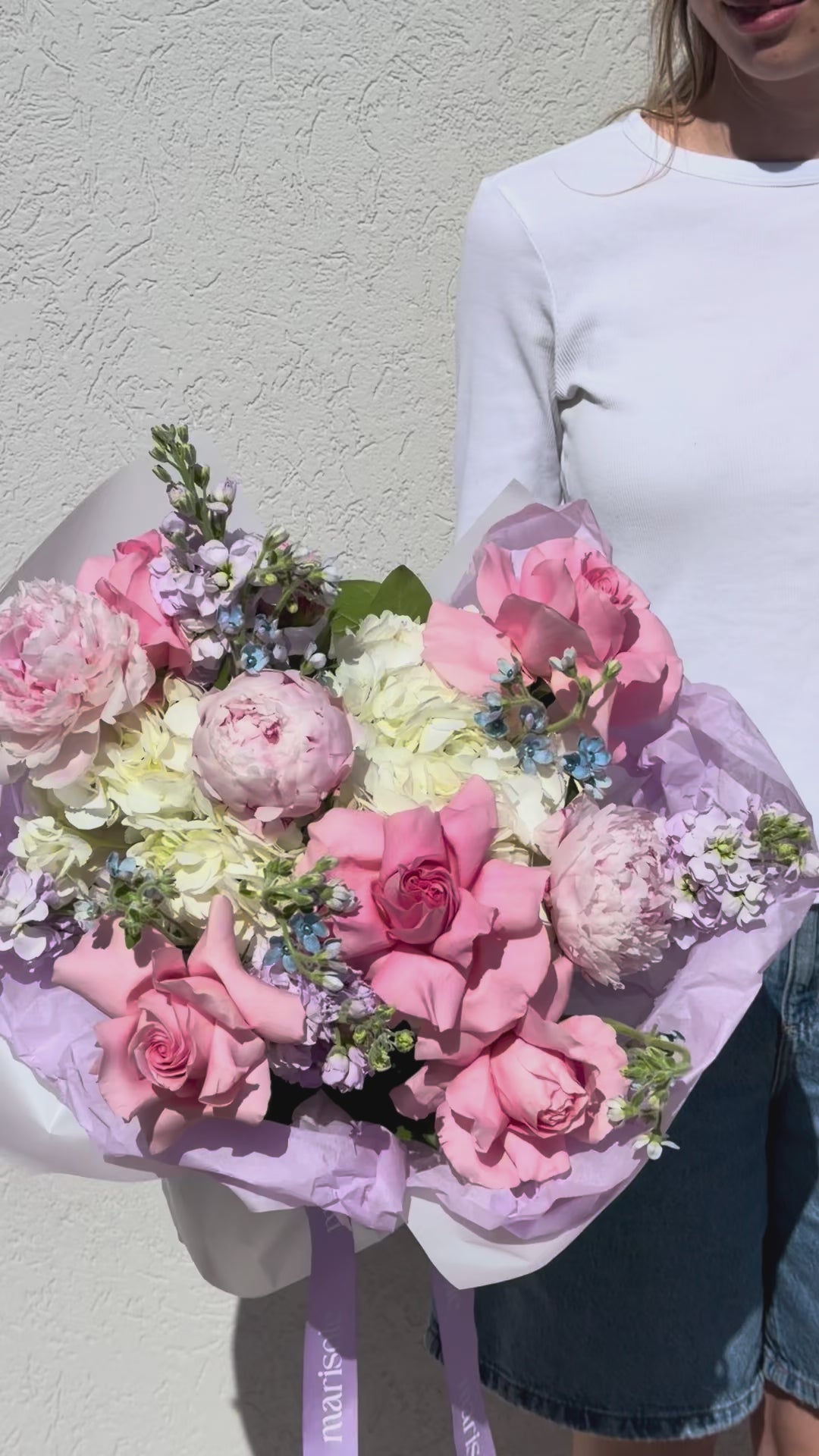 Video of the Warm Greeting Bouquet with peonies, French roses, stock, tweedia, and hydrangea.
