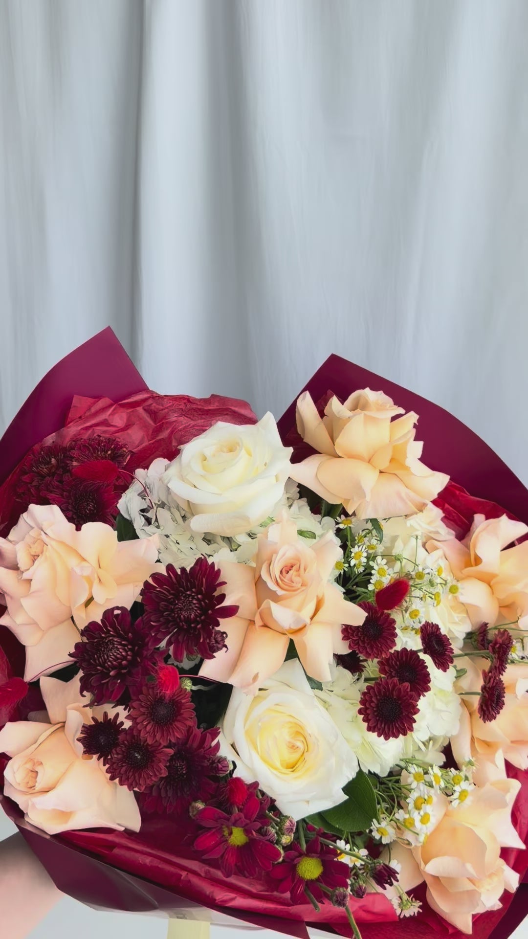 Ember Light Bouquet with hydrangea, French and garden roses, burgundy chrysanthemums, and chamomile.