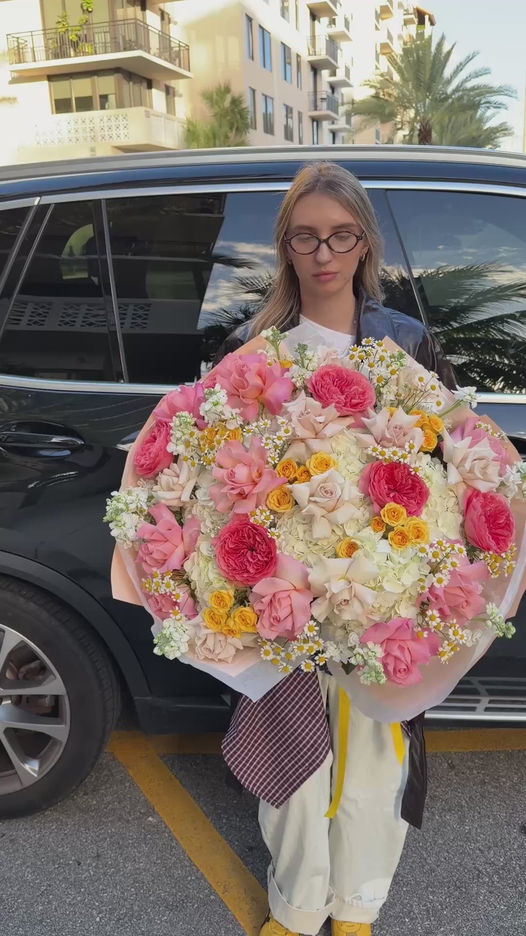 Golden Hour Bouquet featuring pink and cream roses, hydrangeas, yellow spray roses, stock, and chamomile in a lush floral design.