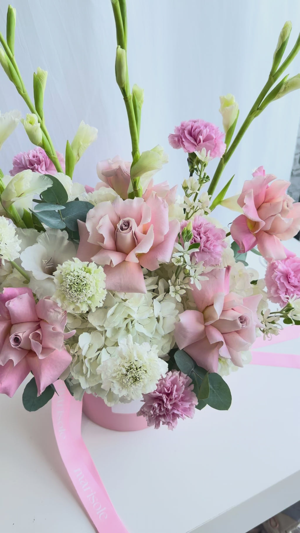 Video of the Pastel Grace Bouquet featuring French roses, gladiolus, hydrangea, carnations, tweedia, and eucalyptus in soft pastel tones.