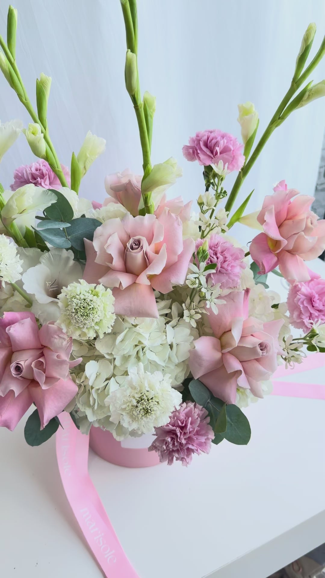 Video of the Pastel Grace Bouquet featuring French roses, gladiolus, hydrangea, carnations, tweedia, and eucalyptus in soft pastel tones.