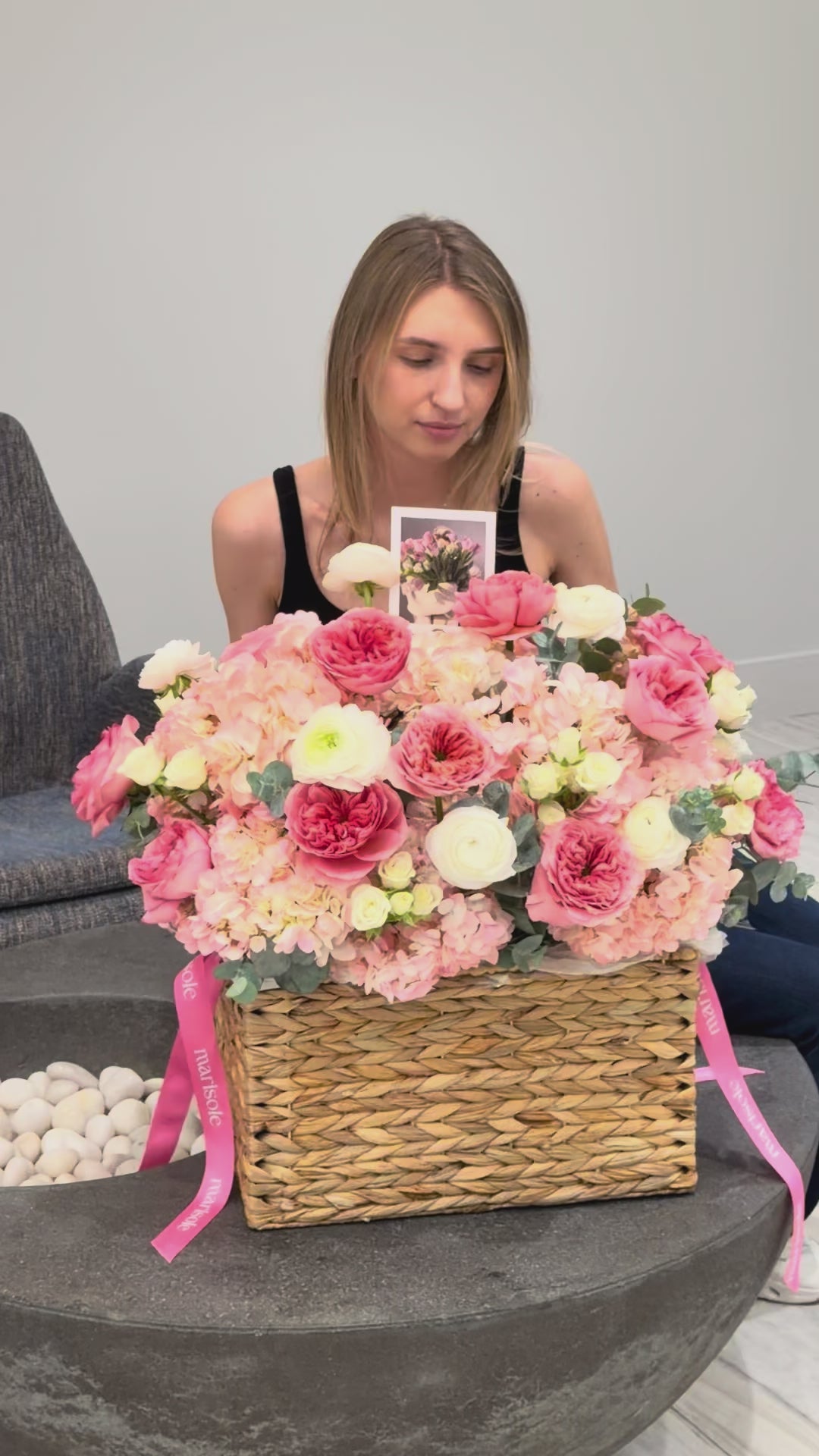 Rosé Reverie flower basket featuring pink garden roses, hydrangeas, ranunculus, spray roses, and eucalyptus in a romantic garden-style design.