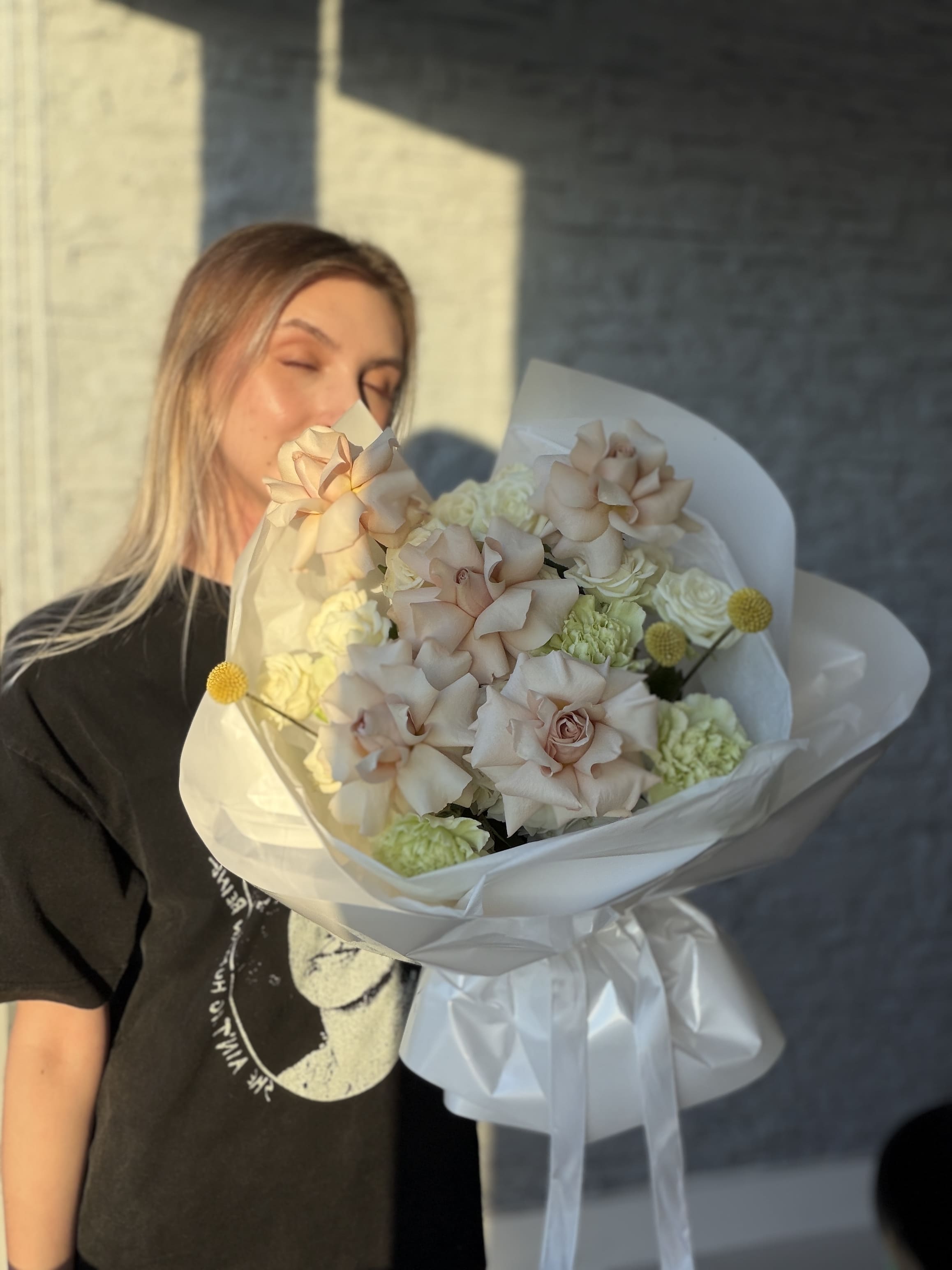 Person holding a bouquet of flowers with a blurred background