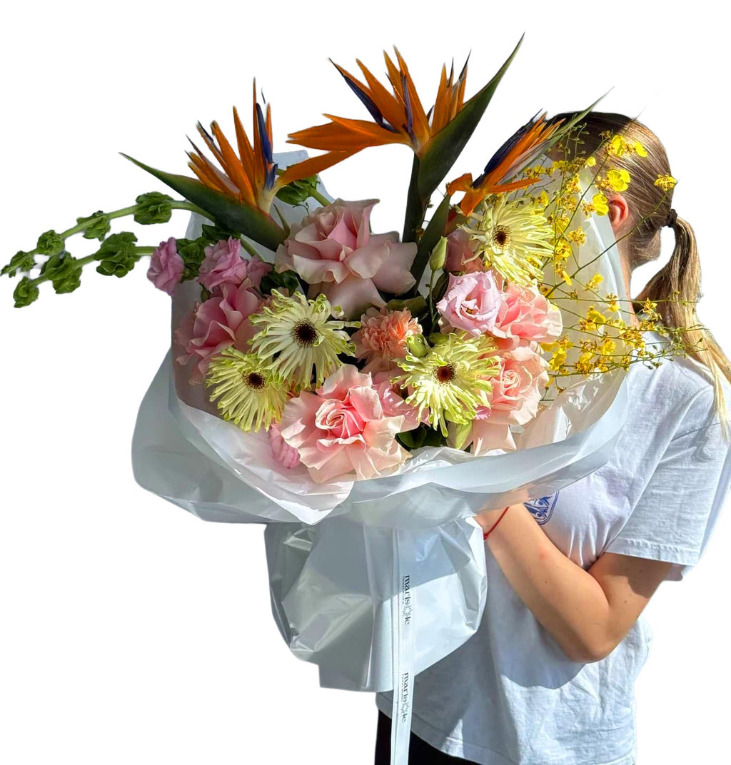 Person holding a large bouquet of flowers with a white background
