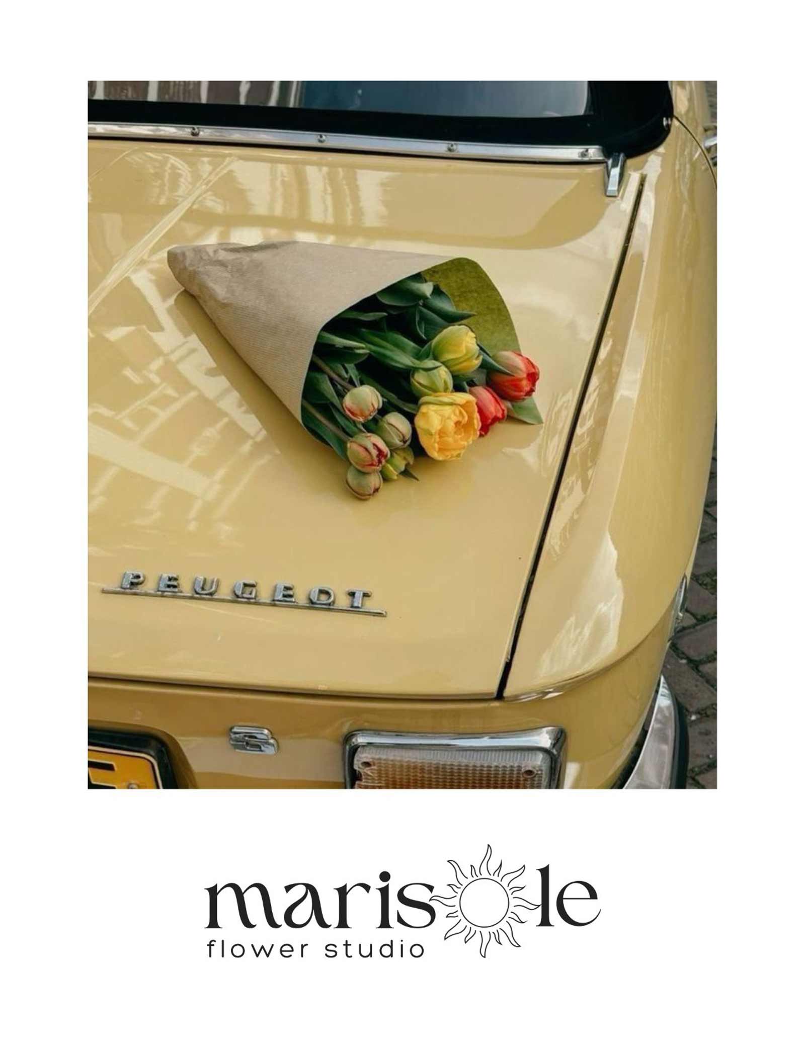 Greeting card with a bouquet of tulips on a vintage car, featuring Marisole Flower Studio logo.
