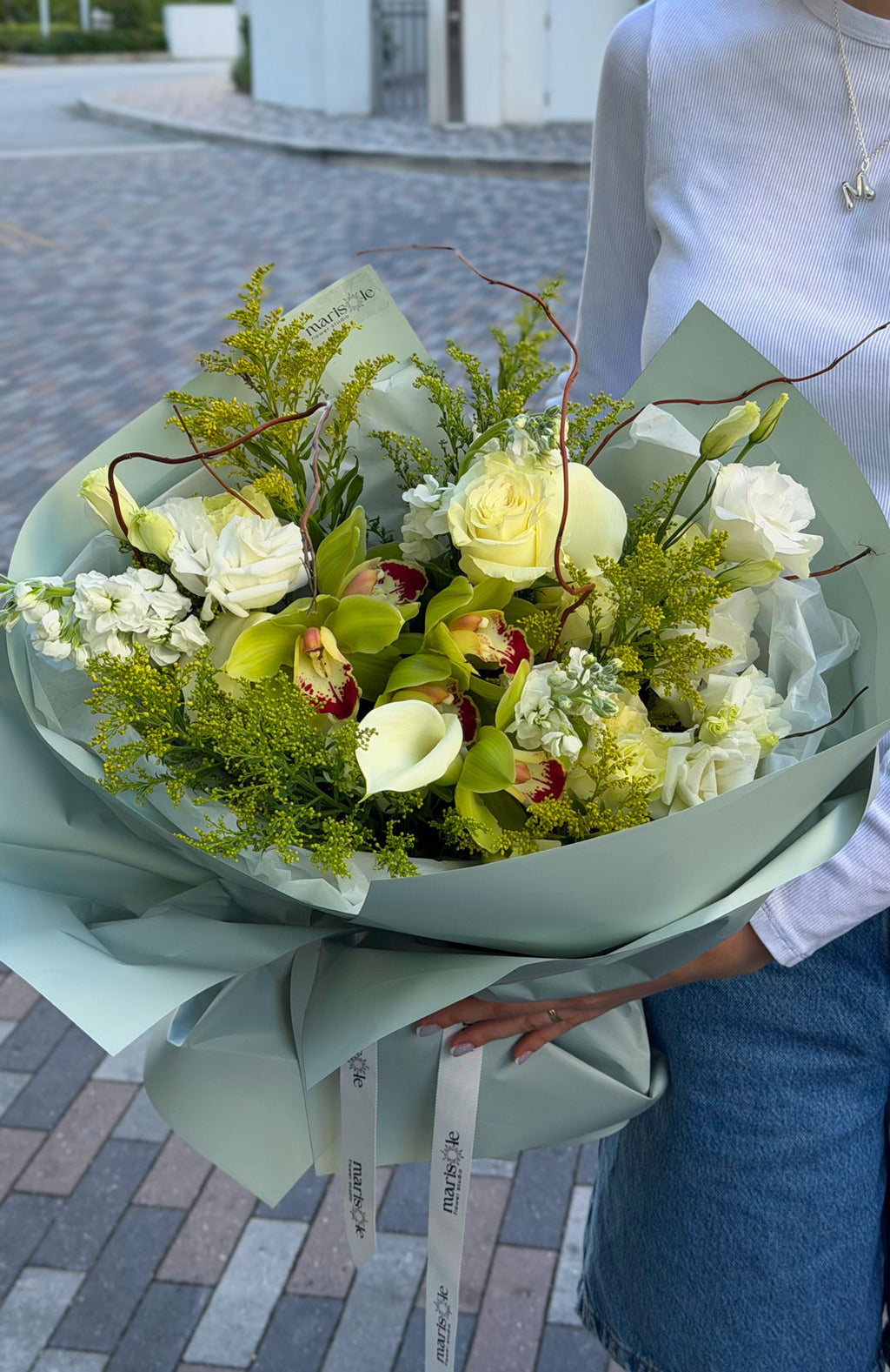Bouquet of flowers held by a person on a street