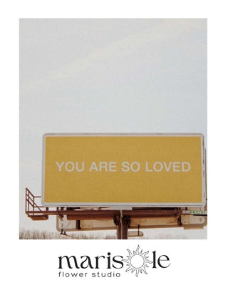 Yellow billboard greeting card with “You Are So Loved” text, featuring Marisole Flower Studio logo.